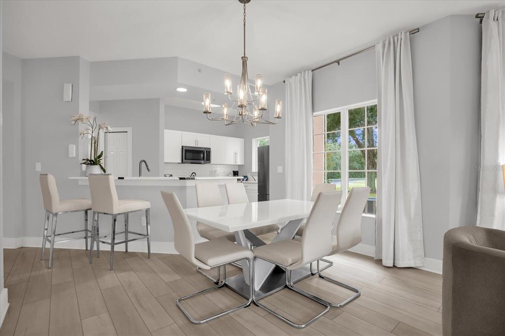 8774 Worldquest Boulevard Orlando, FL 32821 - Photo 9 of 35 a view of a dining room with furniture and chandelier