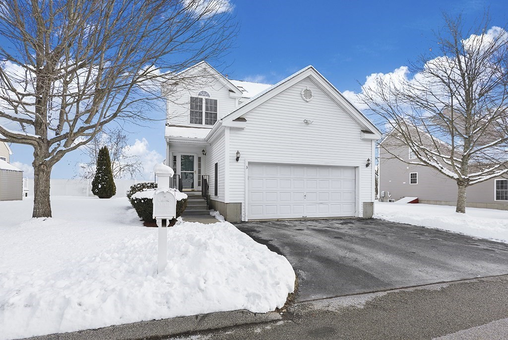 a view of a white house with a yard