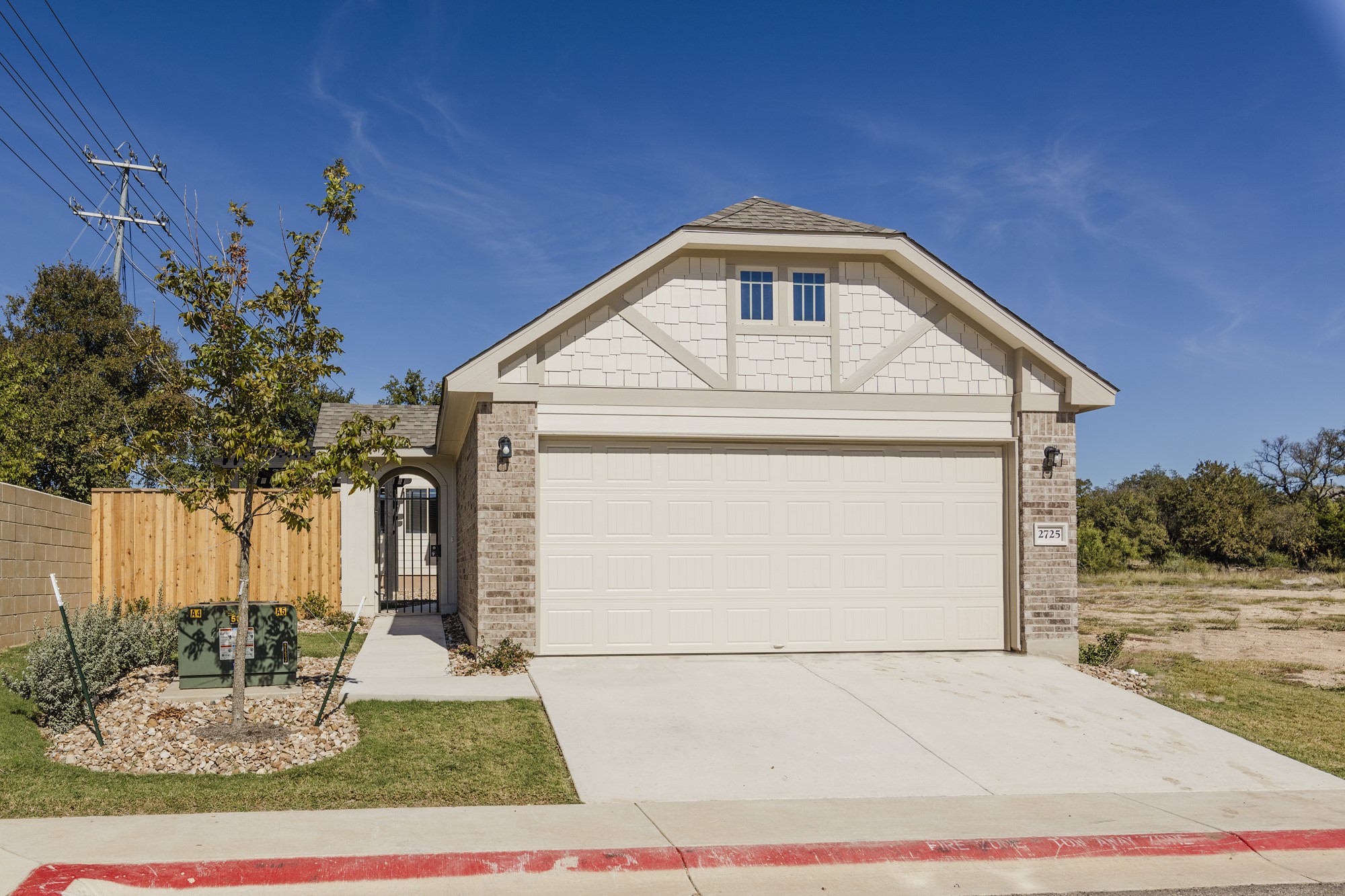 2725 Hopi Path Leander, TX 78641 - Photo 3 of 30 A well-maintained single-story home with a two-car garage and inviting gated entryway.
