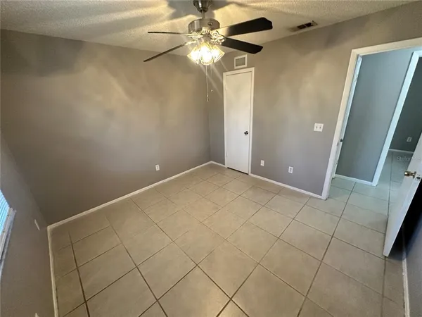 en empty room with fan and window