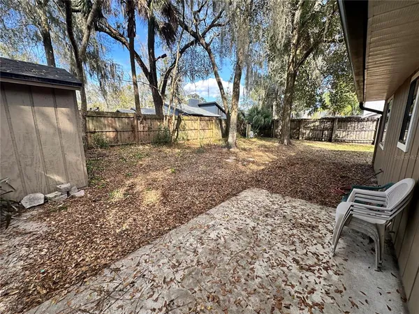 a backyard of a house with outdoor seating