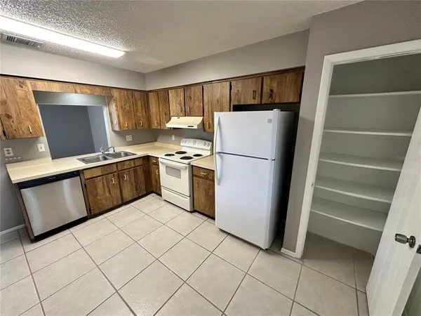 a kitchen with stainless steel appliances a refrigerator sink and microwave