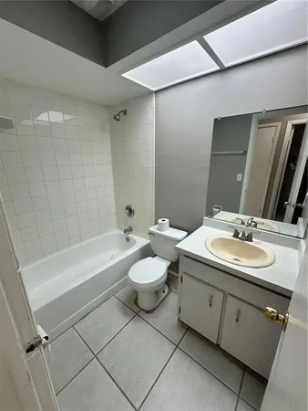 a bathroom with a double vanity sink toilet mirror and bathtub