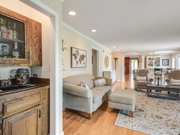 a living room with furniture a flat screen tv and a floor to ceiling window