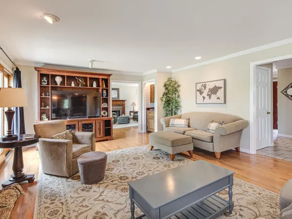 a living room with furniture a large window and a fireplace