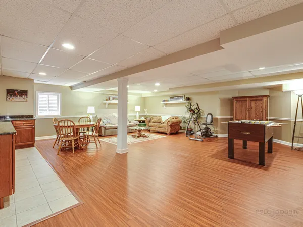 a kitchen with stainless steel appliances granite countertop wooden floors and wooden cabinets