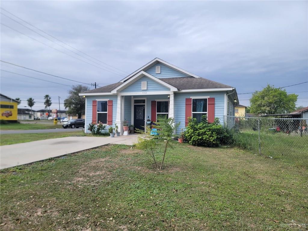 113 Spears Street San Benito, TX 78586 - Photo 1 of 15 a front view of a house with a yard