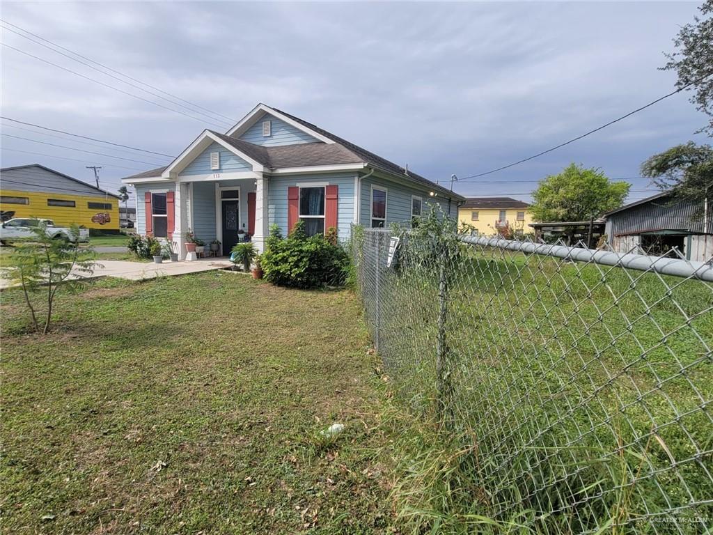 113 Spears Street San Benito, TX 78586 - Photo 13 of 15 a front view of a house with a yard