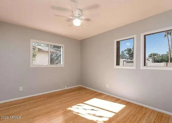 a bathroom with a granite countertop toilet sink and mirror