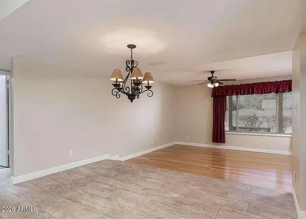 a view of a room with wooden floor and a window