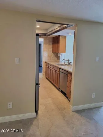 a kitchen with granite countertop a sink and cabinets
