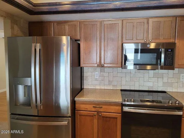 a kitchen with a refrigerator sink and microwave