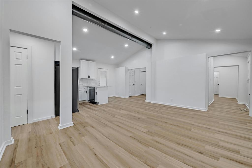 1911 David Street Austin, TX 78705 - Photo 1 of 1 Unfurnished living room featuring light wood-style flooring, recessed lighting, baseboards, high vaulted ceiling, and beamed ceiling