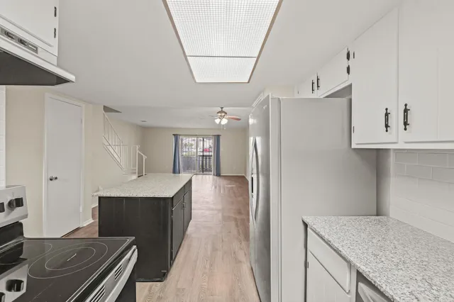 a kitchen with refrigerator cabinets and a counter top space