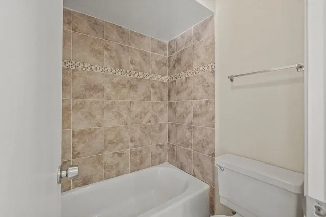 a bathroom with a shower and a toilet