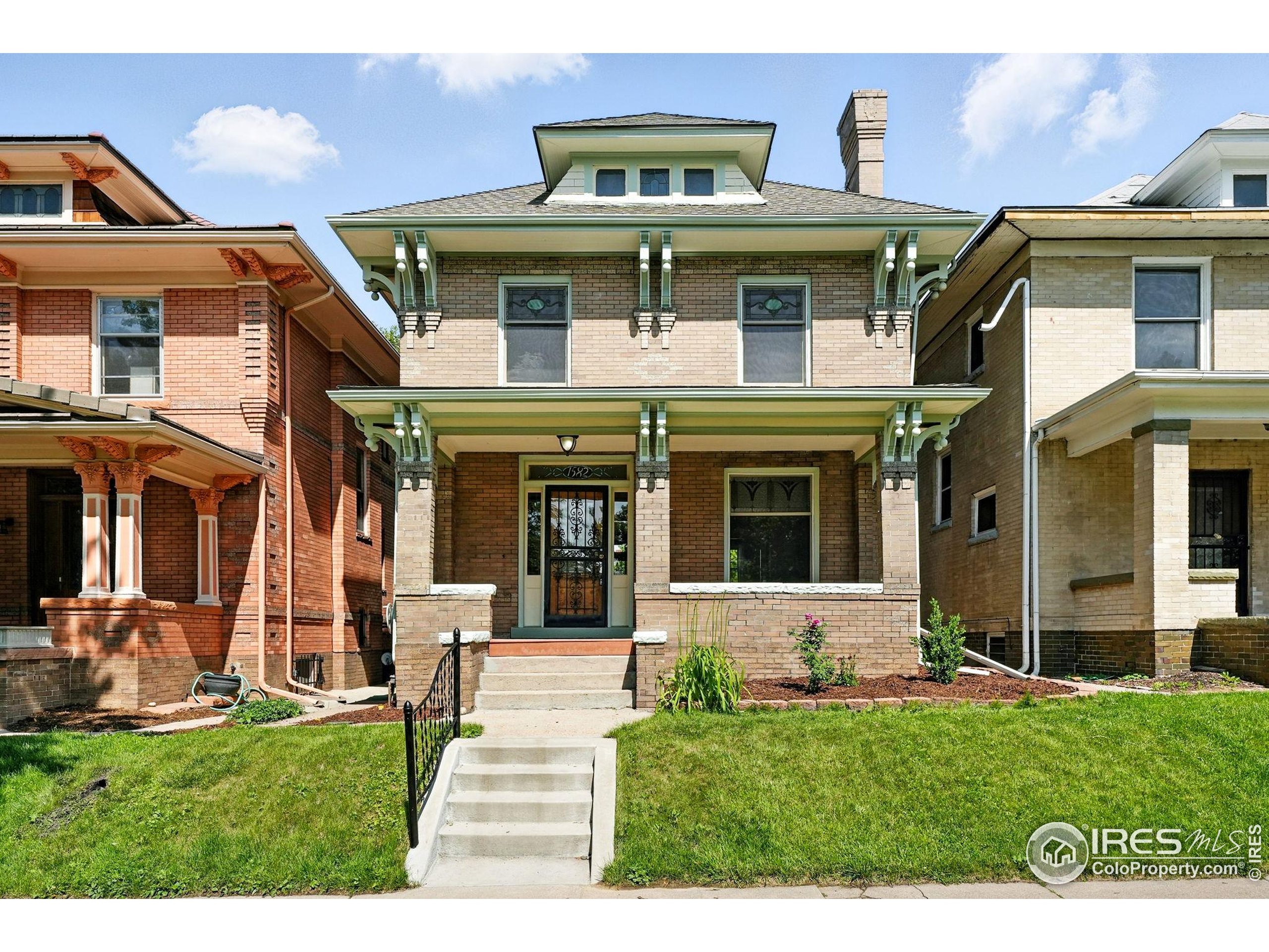 1582 Steele Street Denver, CO 80206 - Photo 1 of 48 a front view of a house with a yard