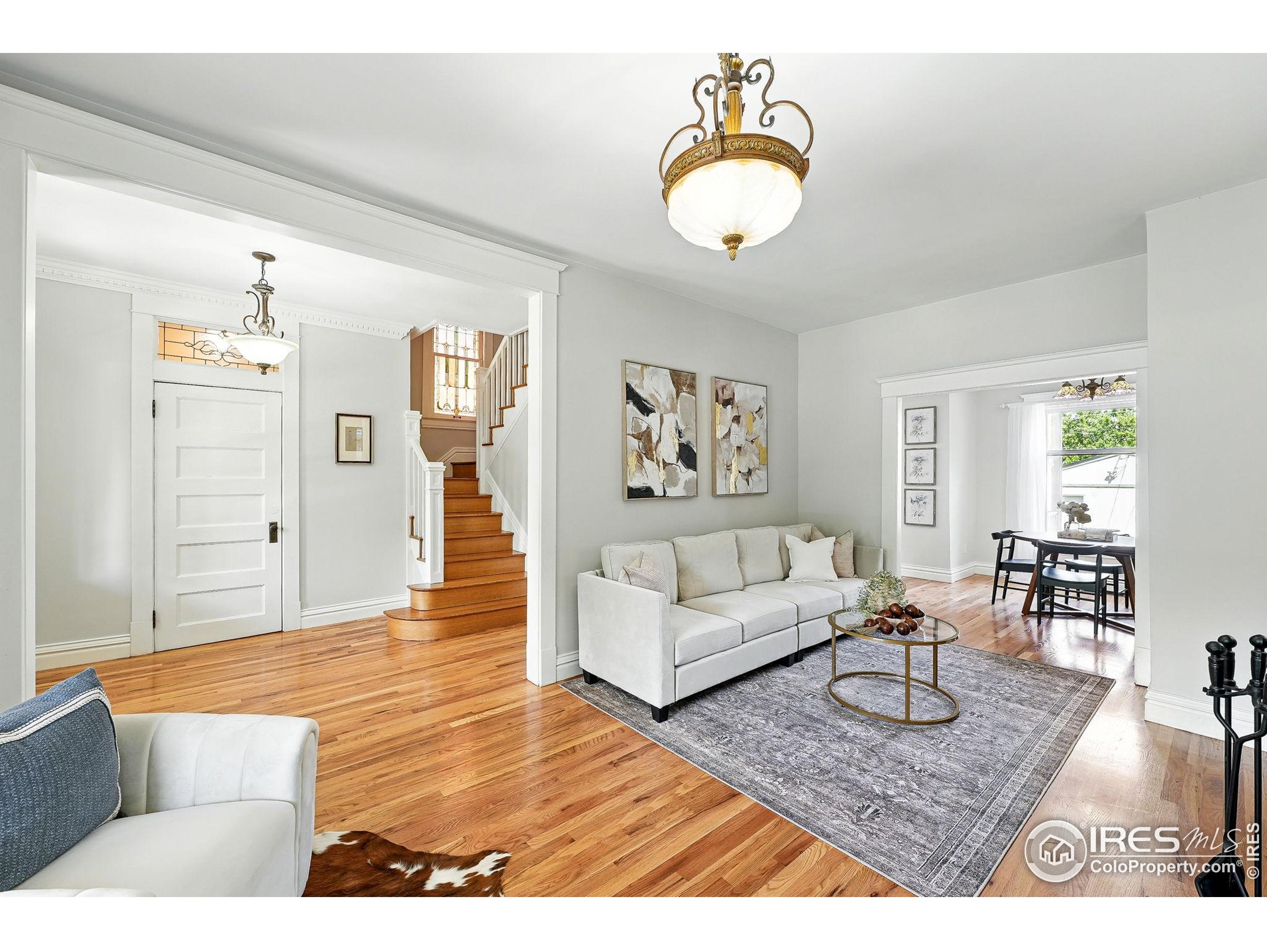 1582 Steele Street Denver, CO 80206 - Photo 11 of 48 a living room with furniture and wooden floor