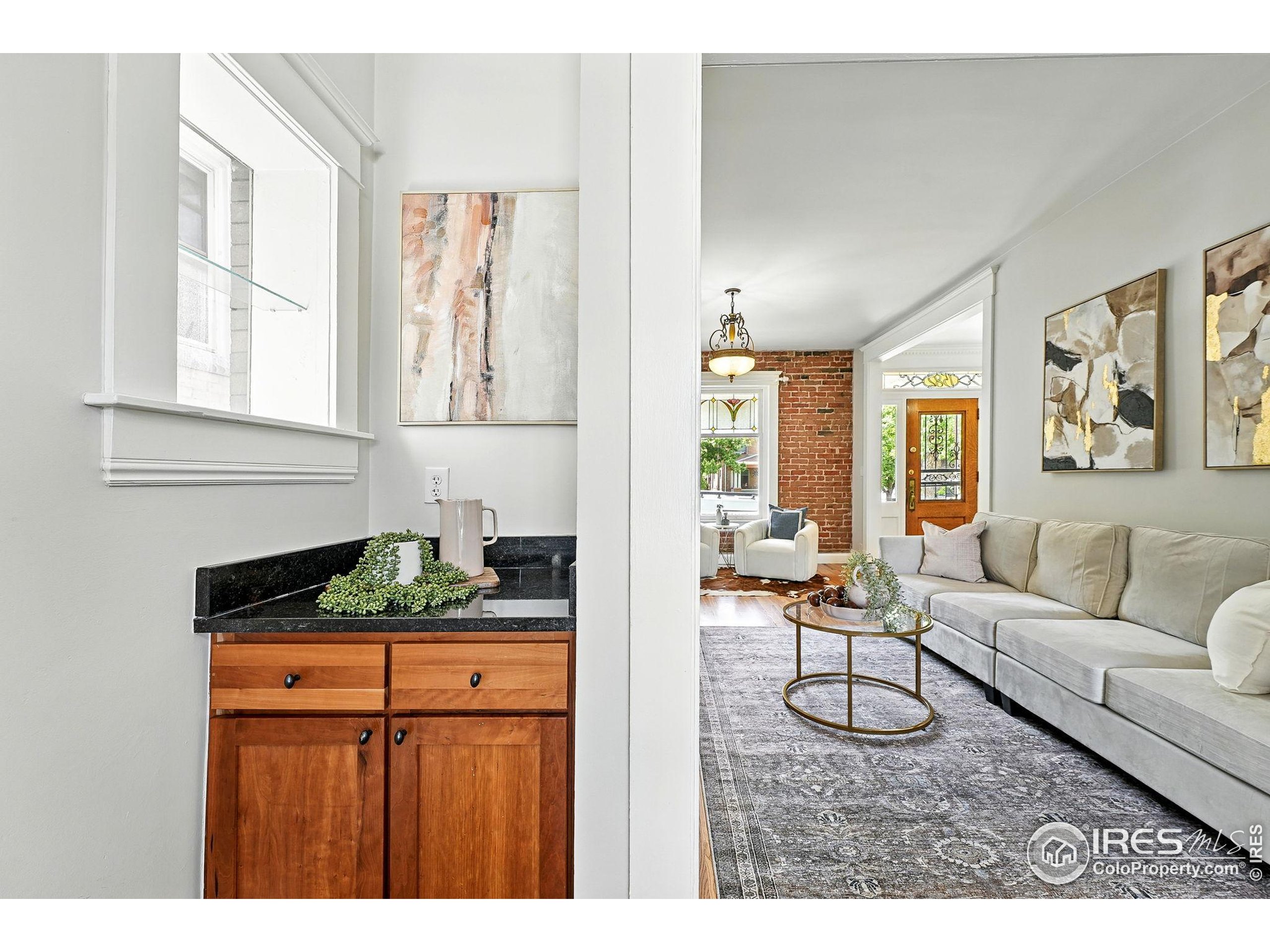 1582 Steele Street Denver, CO 80206 - Photo 15 of 48 a living room with furniture and a flat screen tv
