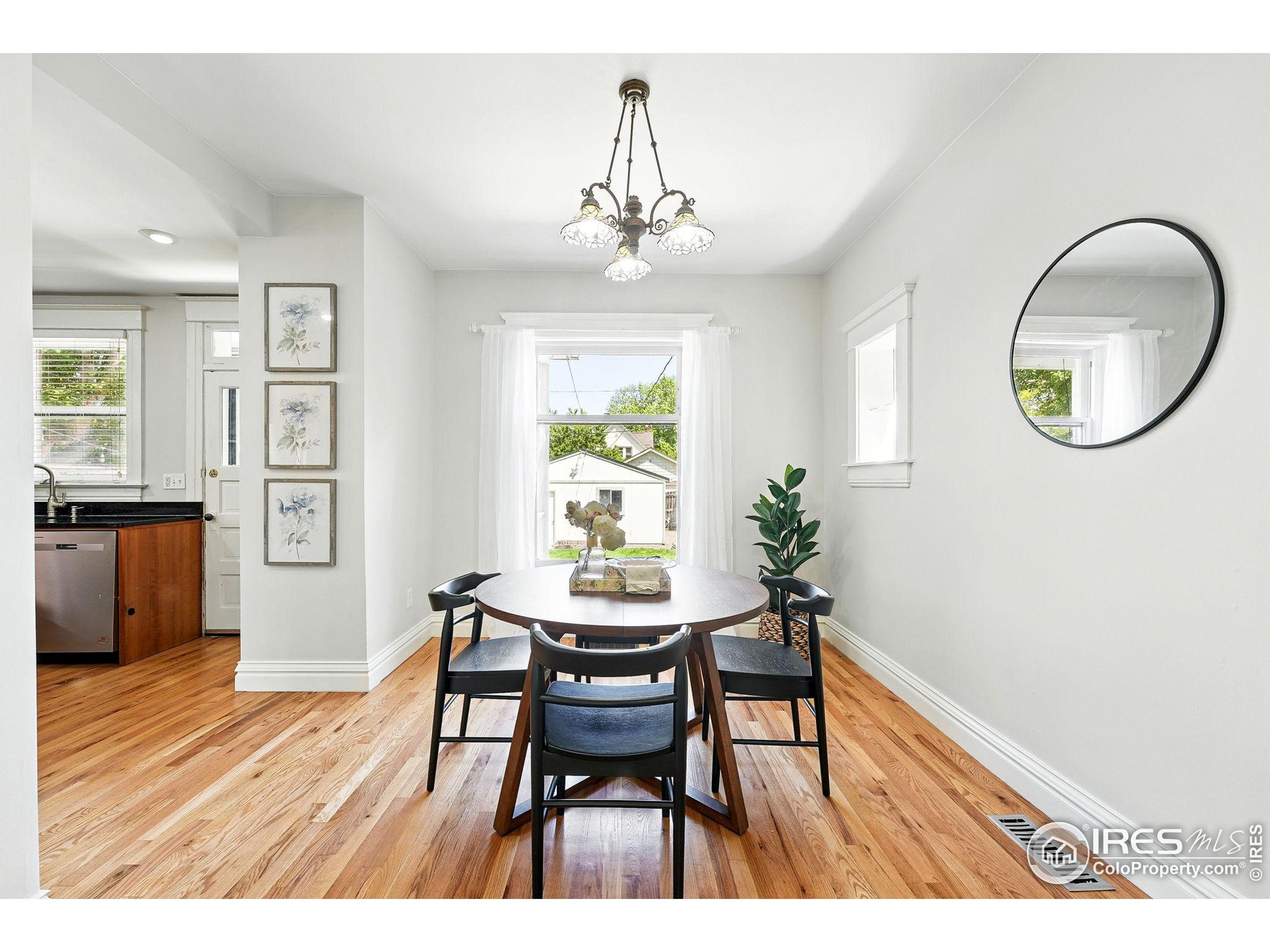 1582 Steele Street Denver, CO 80206 - Photo 16 of 48 a view of a dining room with furniture window and wooden floor