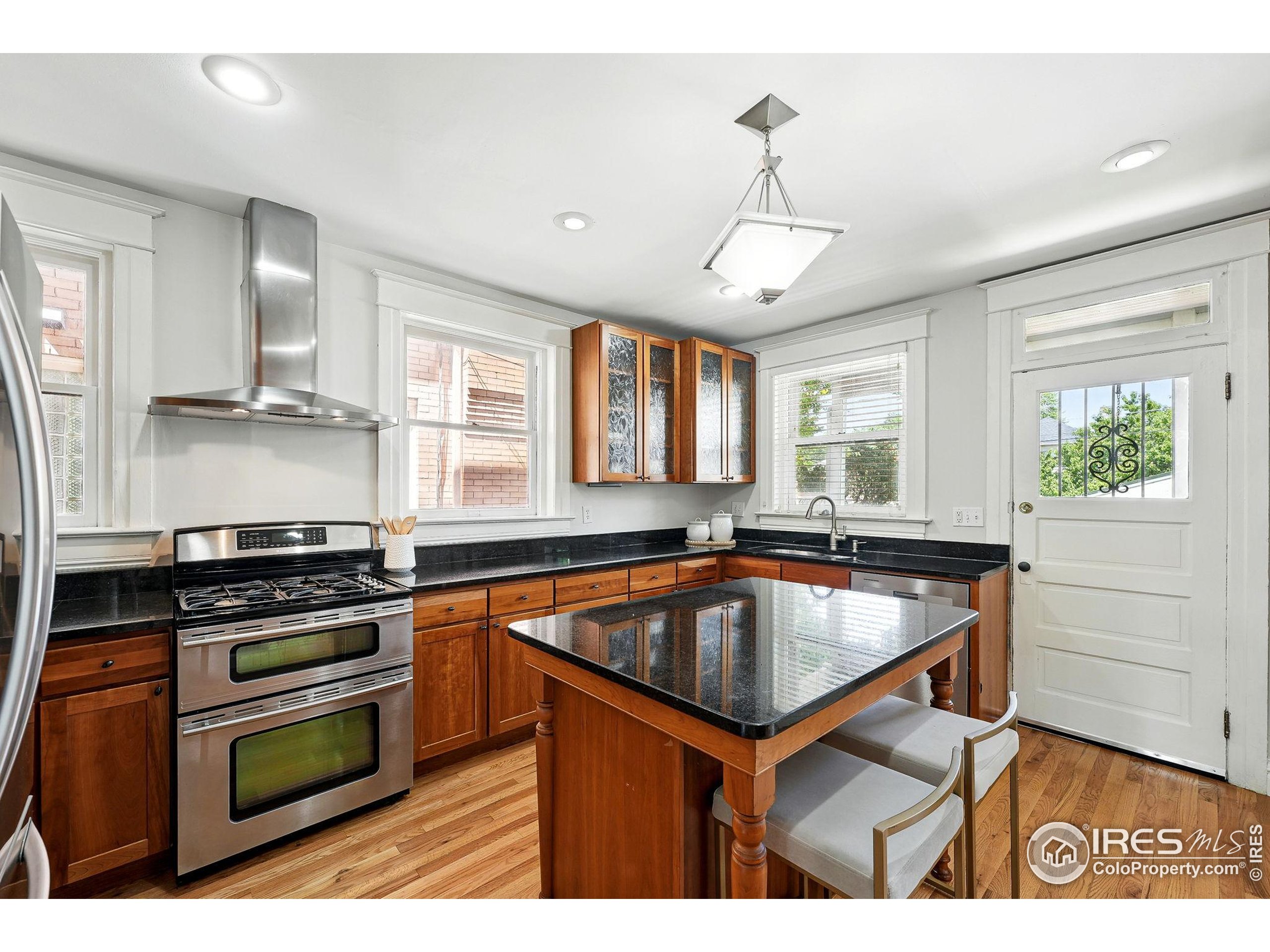 1582 Steele Street Denver, CO 80206 - Photo 20 of 48 a kitchen with a sink stove and window