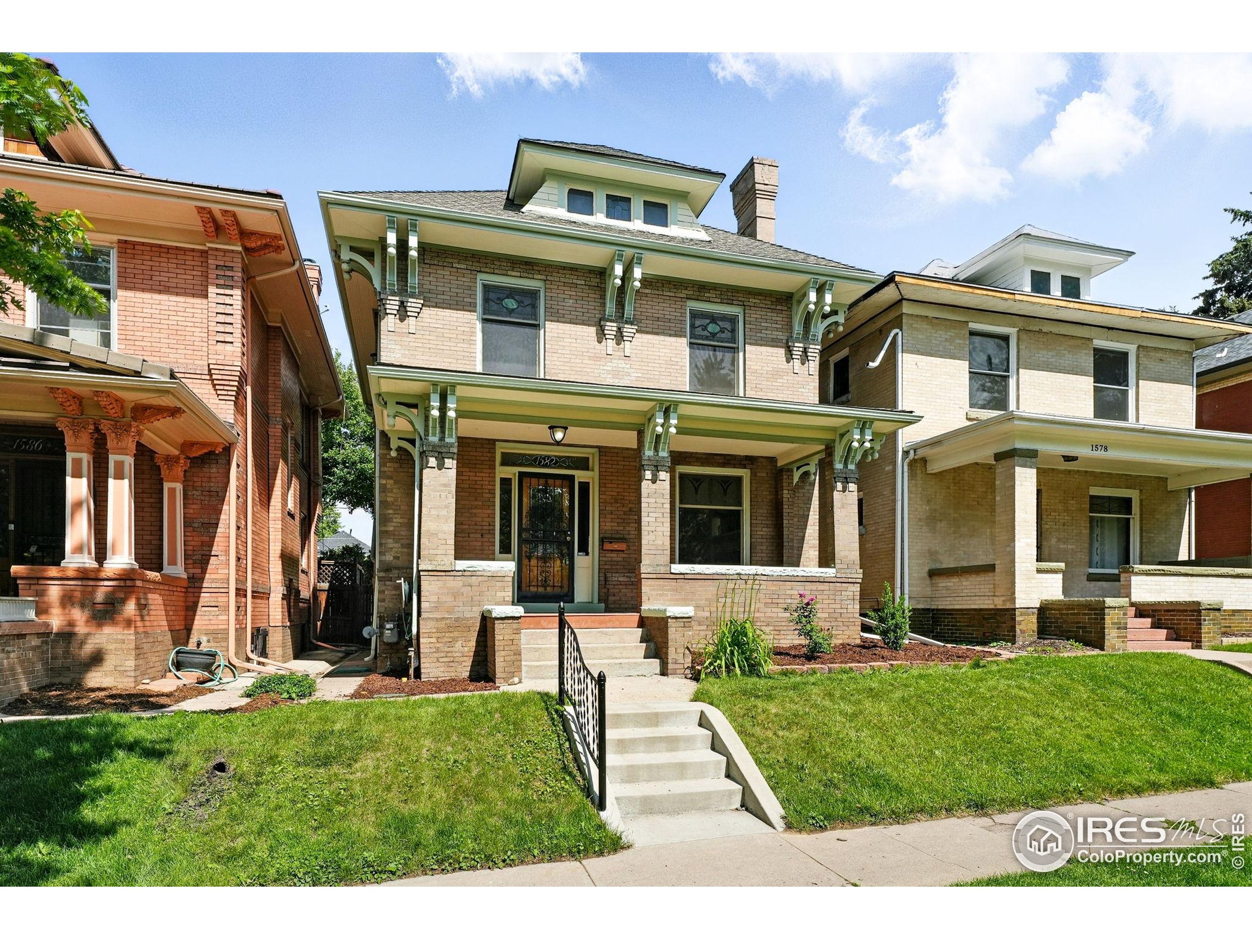 1582 Steele Street Denver, CO 80206 - Photo 2 of 48 a front view of a house with a yard