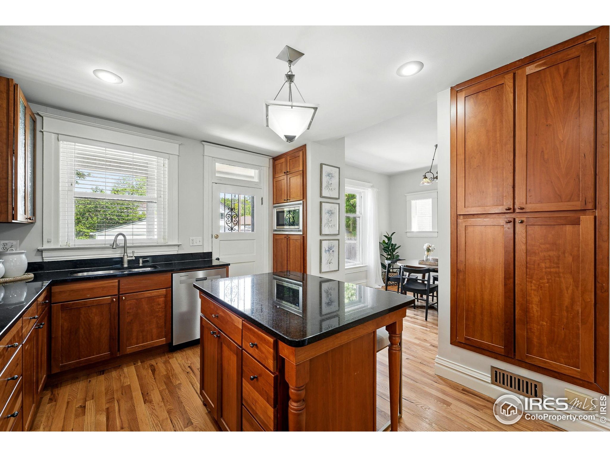 1582 Steele Street Denver, CO 80206 - Photo 21 of 48 a kitchen with stainless steel appliances granite countertop a sink a stove and a refrigerator