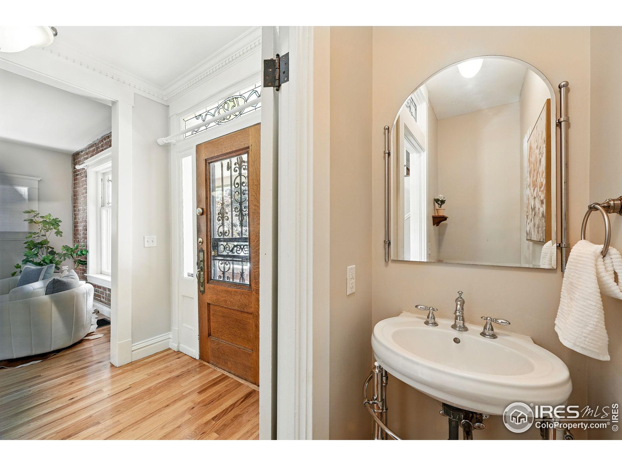 1582 Steele Street Denver, CO 80206 - Photo 22 of 48 a bathroom with a sink and a mirror