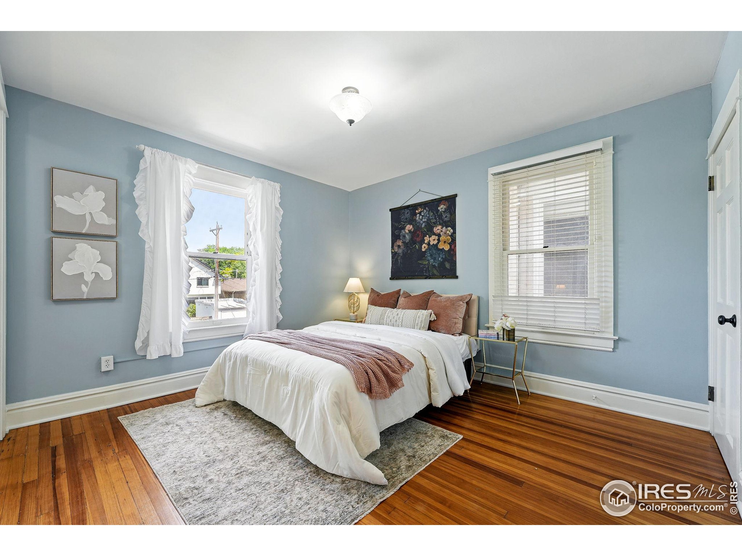 1582 Steele Street Denver, CO 80206 - Photo 26 of 48 a bedroom with a bed and a window