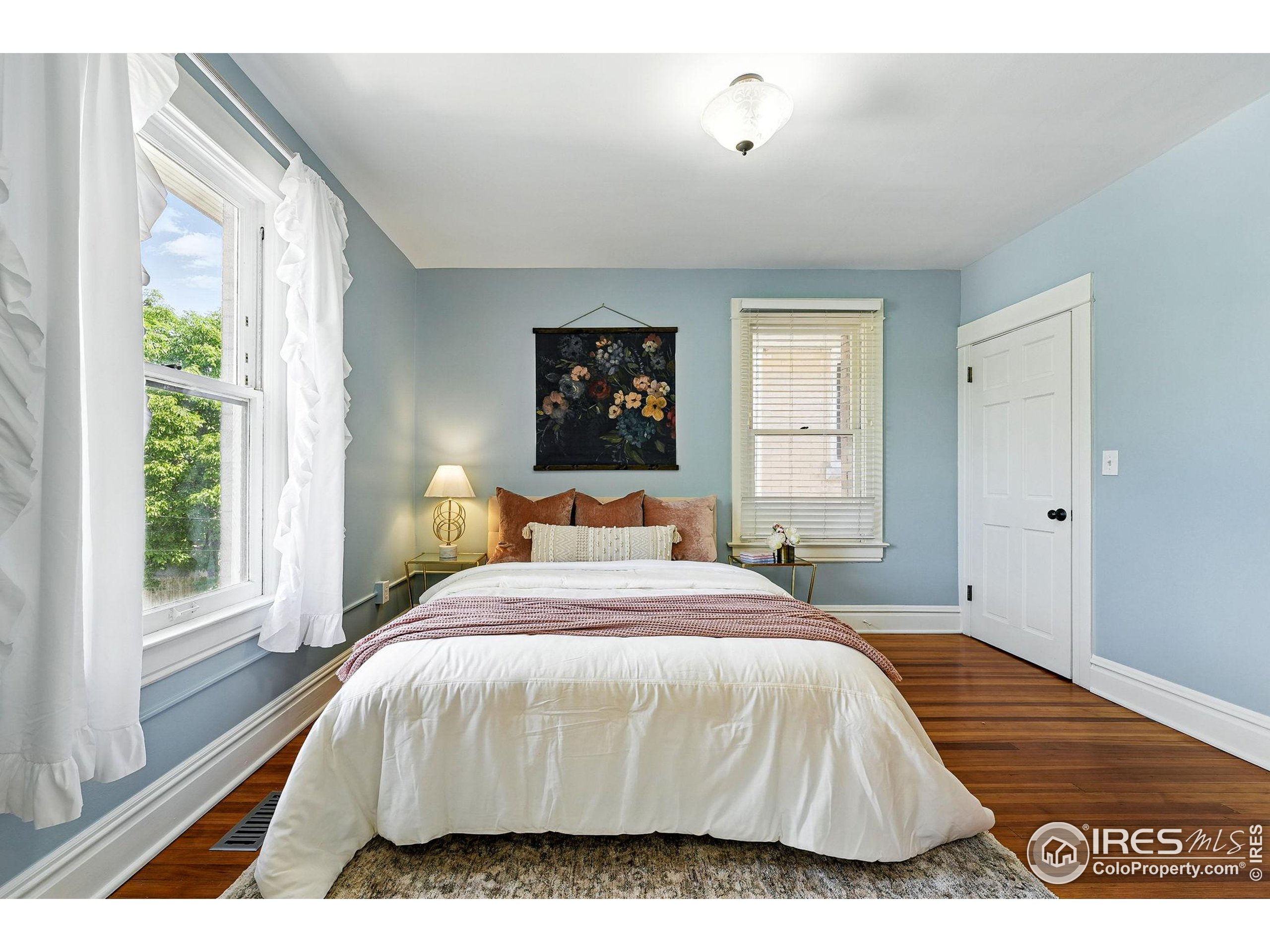 1582 Steele Street Denver, CO 80206 - Photo 27 of 48 a bedroom with a bed and a window