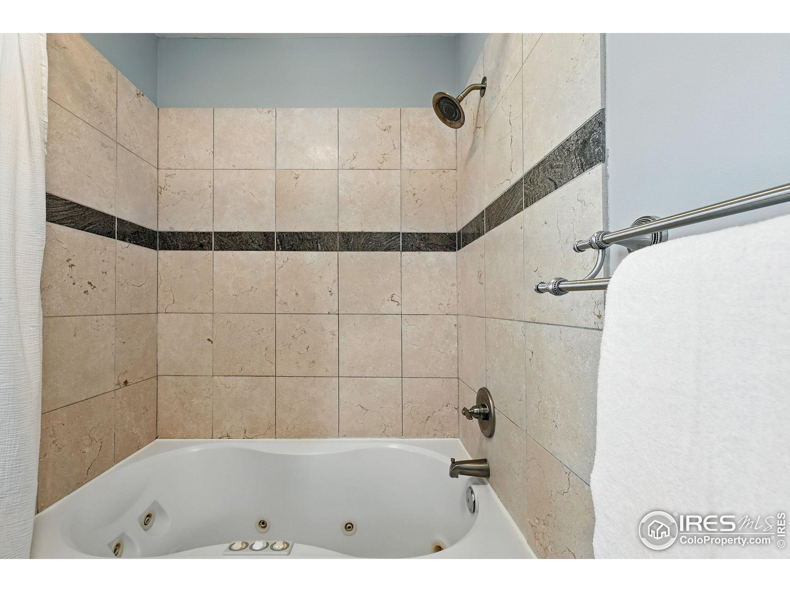 1582 Steele Street Denver, CO 80206 - Photo 29 of 48 a bathroom with a bathtub and a shower