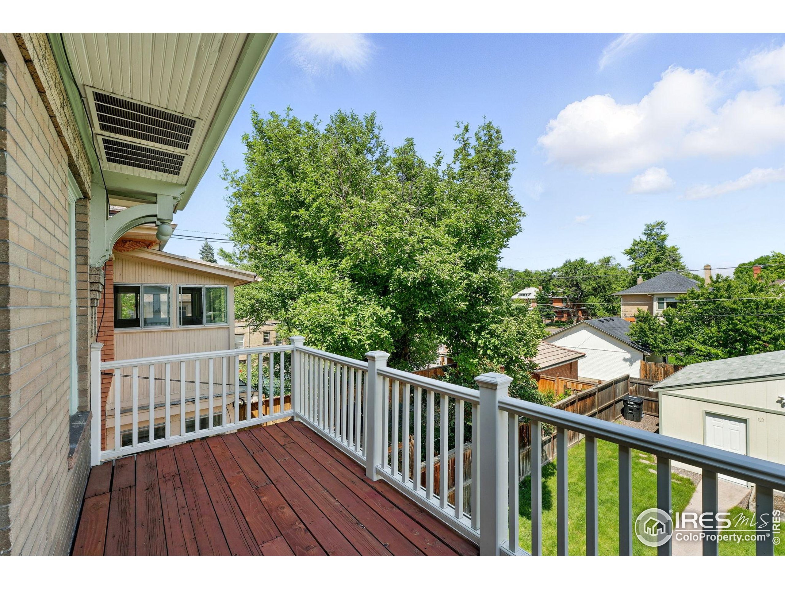 1582 Steele Street Denver, CO 80206 - Photo 30 of 48 a view of balcony with wooden floor and fence