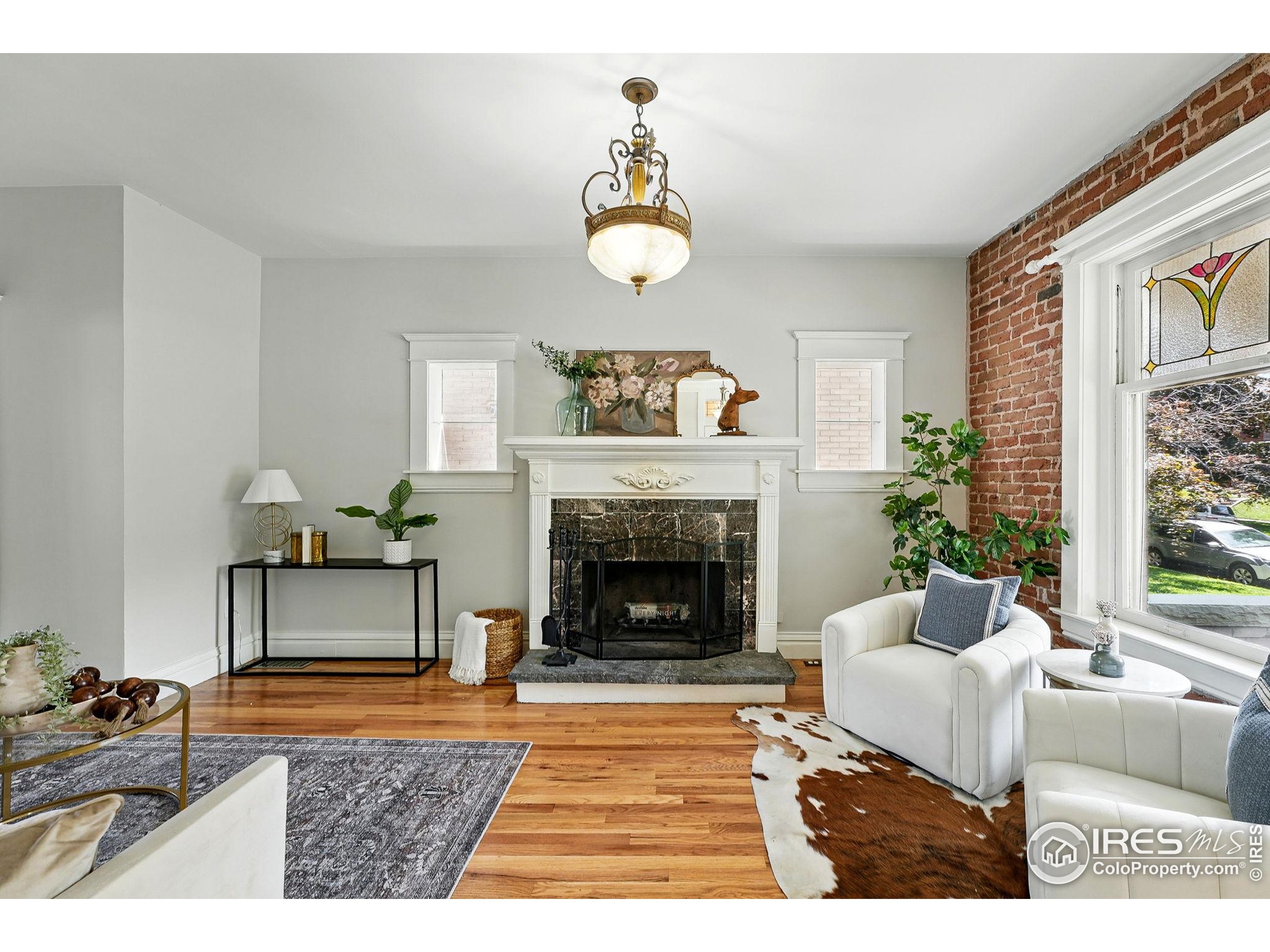 1582 Steele Street Denver, CO 80206 - Photo 3 of 48 a living room with furniture and a fireplace