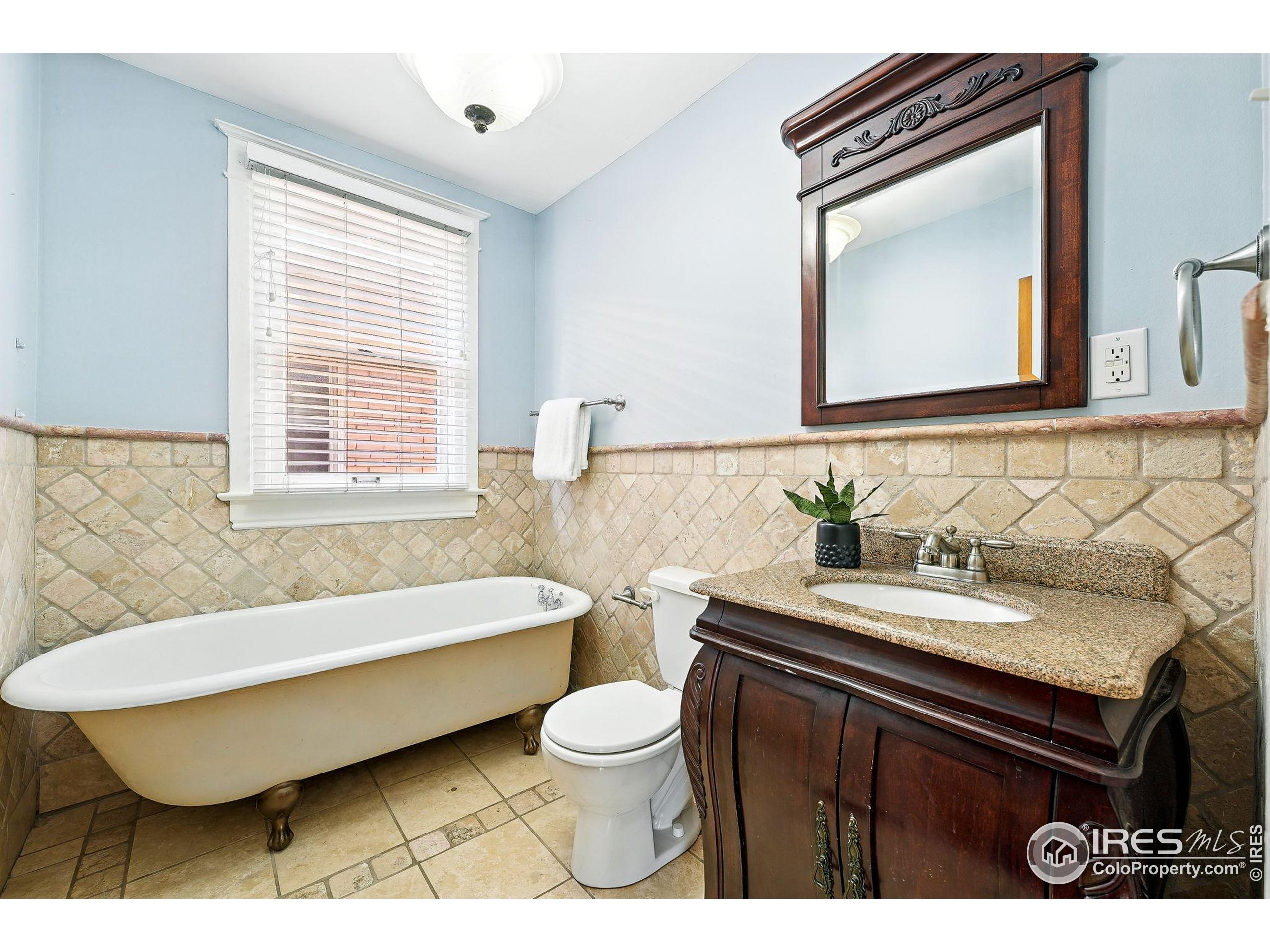 1582 Steele Street Denver, CO 80206 - Photo 33 of 48 a bathroom with a sink and a mirror