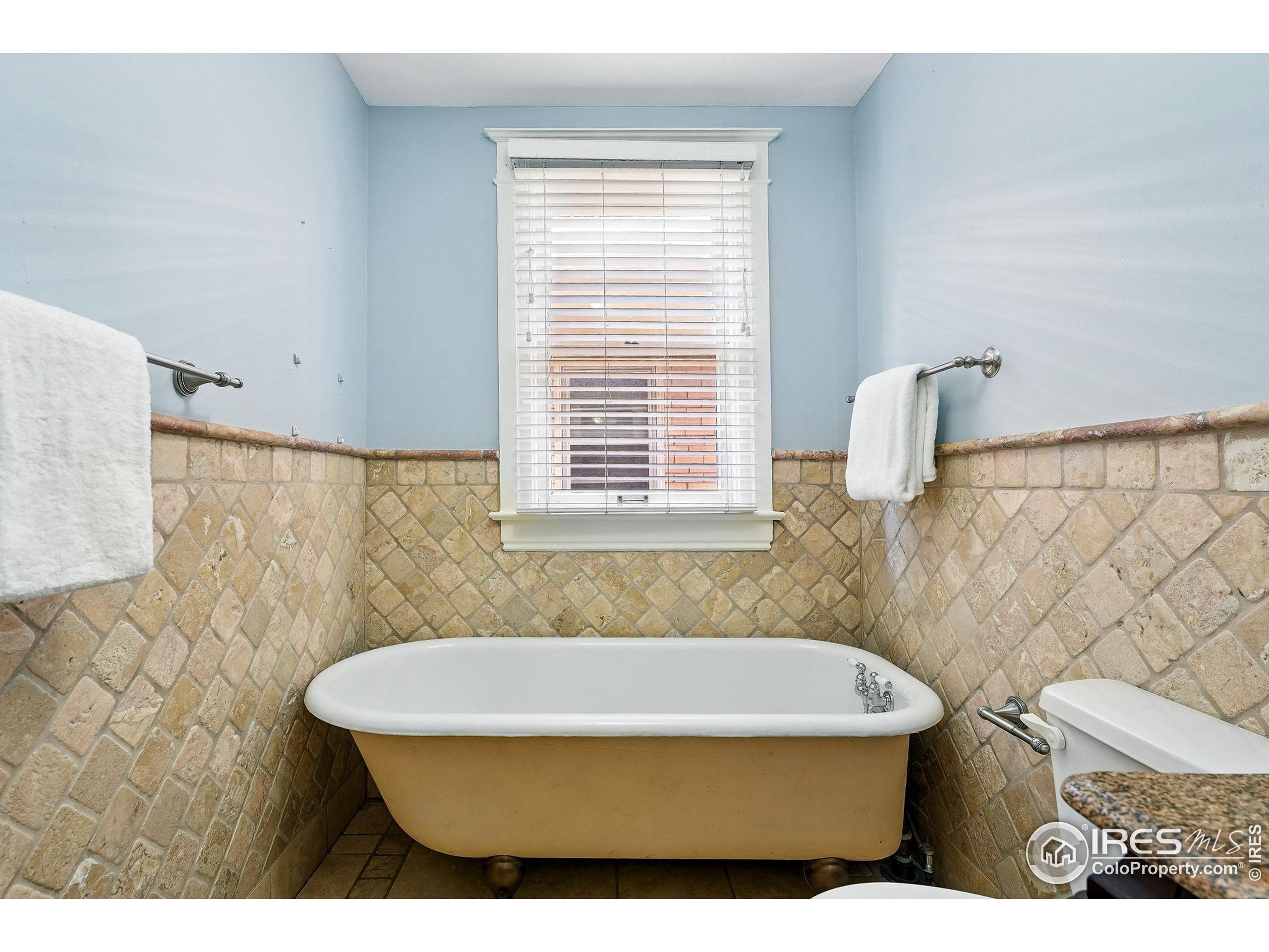 1582 Steele Street Denver, CO 80206 - Photo 34 of 48 a bathroom with a sink and a bathtub