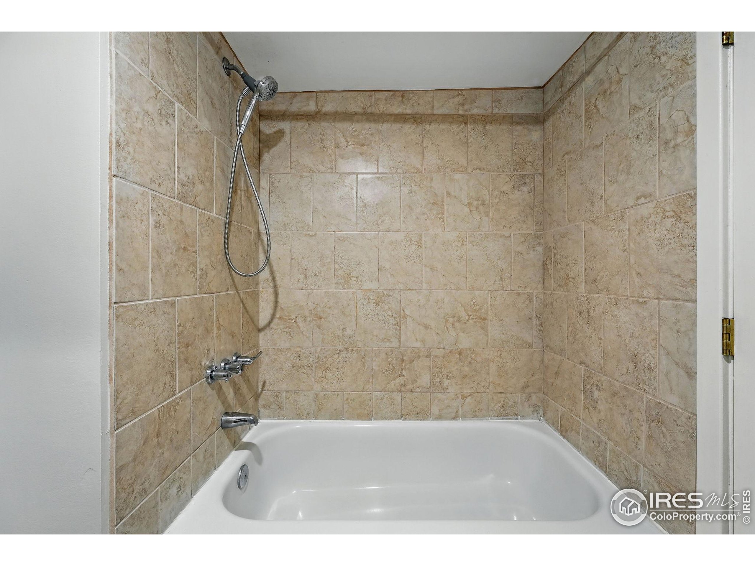 1582 Steele Street Denver, CO 80206 - Photo 38 of 48 a bathroom with a shower and a bath tub