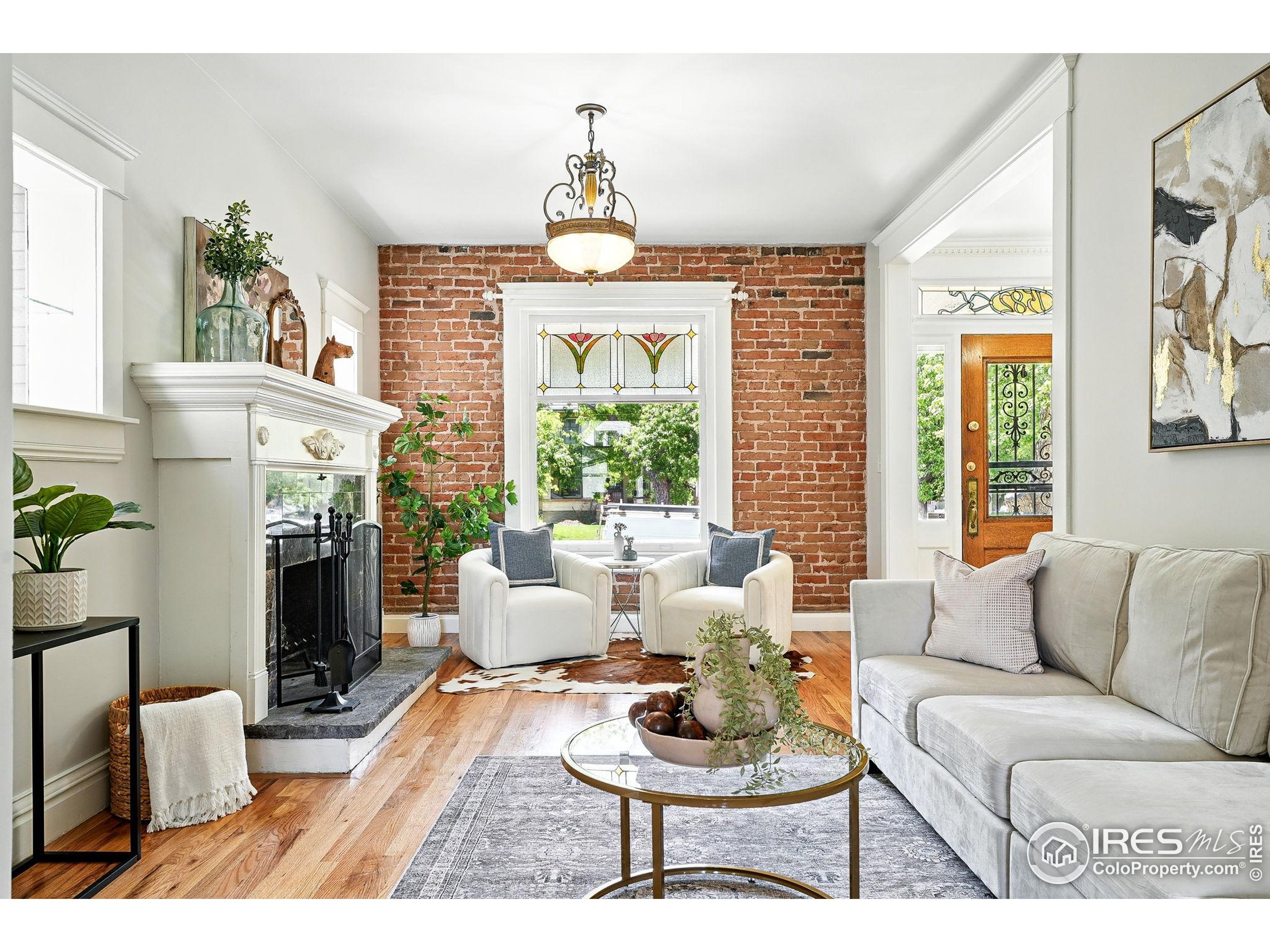 1582 Steele Street Denver, CO 80206 - Photo 4 of 48 a living room with furniture a fireplace and a large window