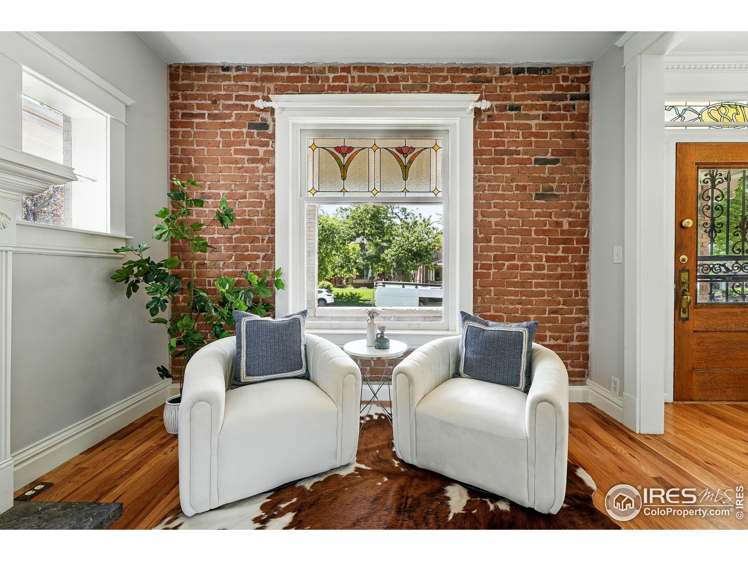 1582 Steele Street Denver, CO 80206 - Photo 8 of 48 a living room with furniture and a potted plant