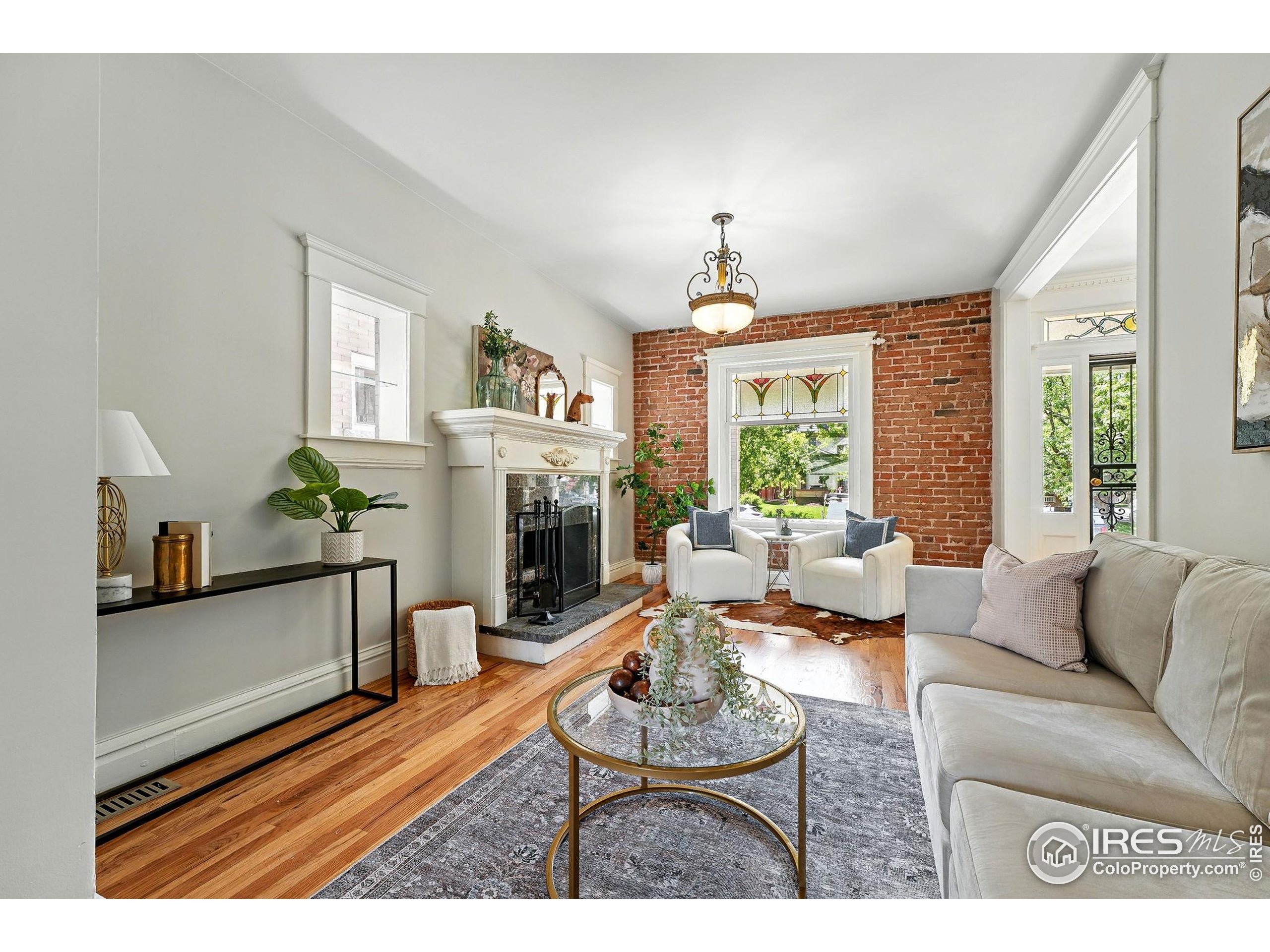 1582 Steele Street Denver, CO 80206 - Photo 9 of 48 a living room with furniture and a fireplace