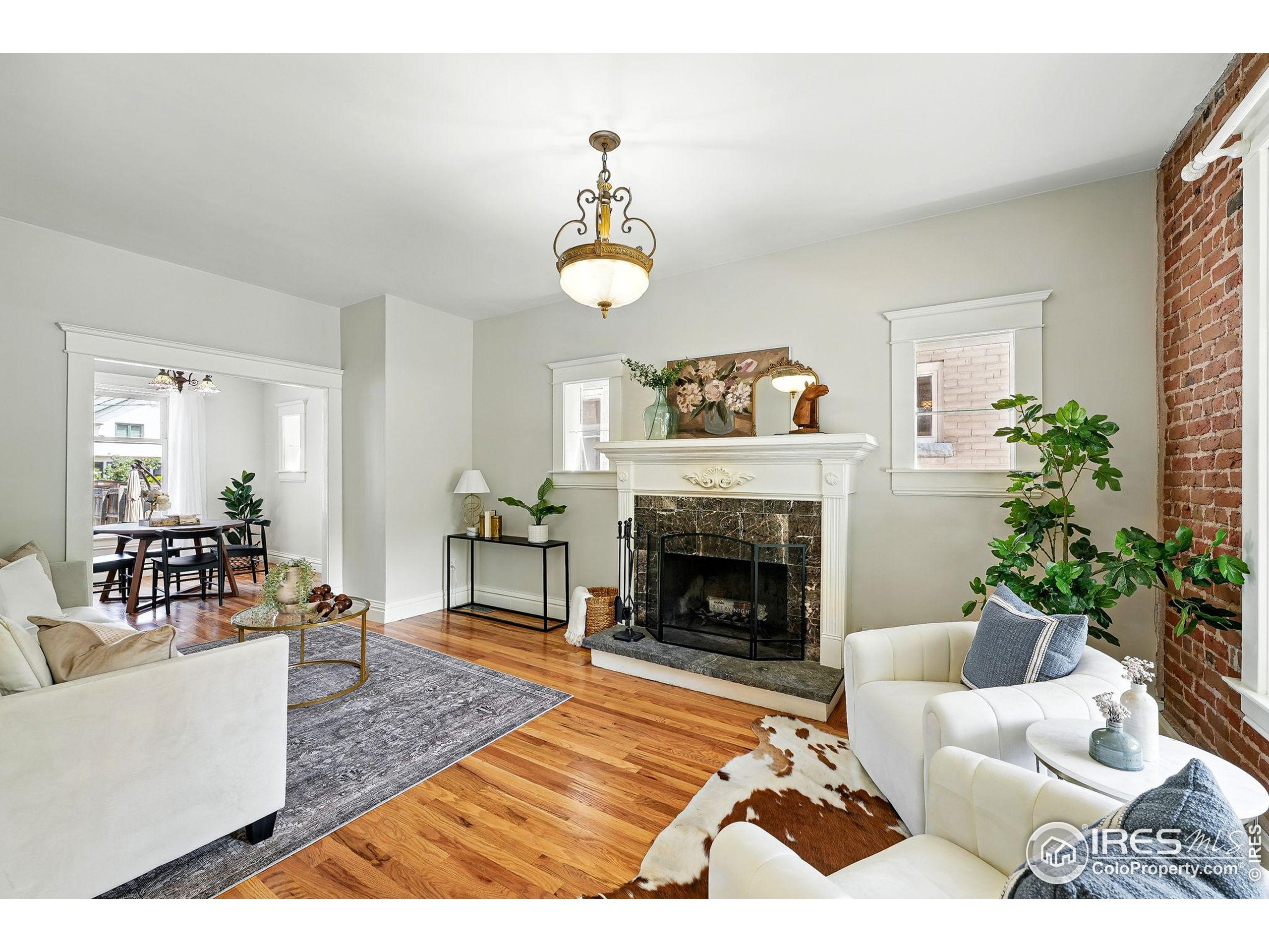 1582 Steele Street Denver, CO 80206 - Photo 10 of 48 a living room with furniture and a fireplace