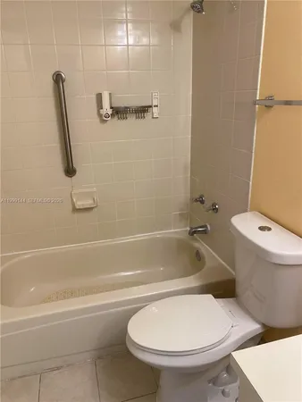 a bathroom with a toilet and a bath tub