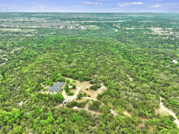 a view of a green field with lots of bushes