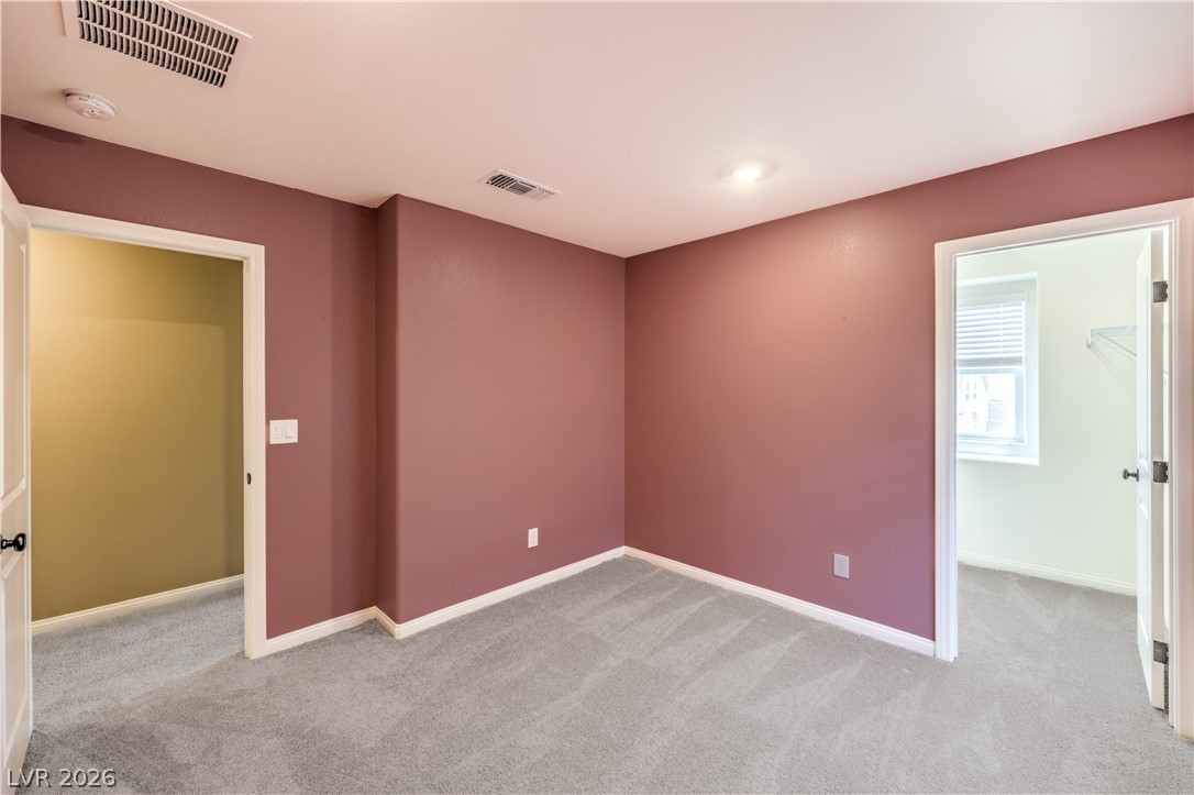 3782 Alla Rocca Avenue Henderson, NV 89044 - Photo 32 of 55 This spacious bedroom offers comfortable carpeted flooring and ample natural light.