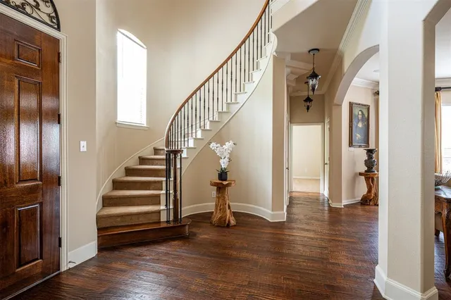 a view of entryway with wooden floor and staircase