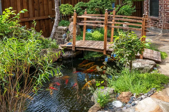 a backyard of a house with a garden and outdoor seating