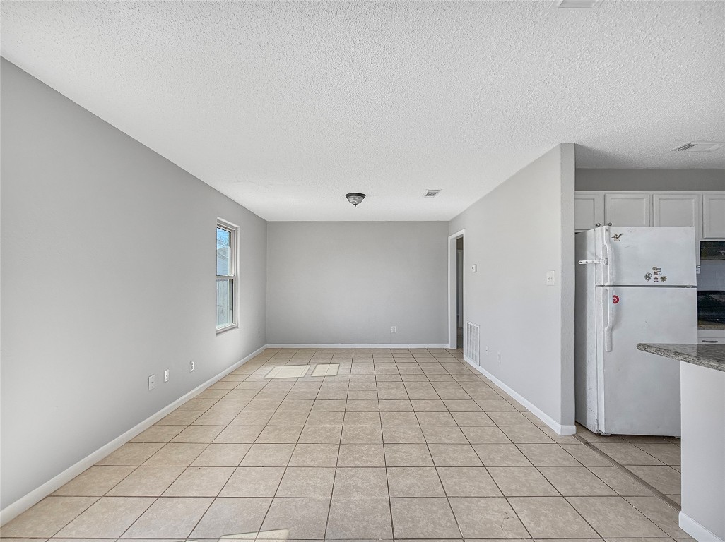 114 8th Street Rosenberg, TX 77471 - Photo 17 of 19 a view of a livingroom with an empty space and a refrigerator