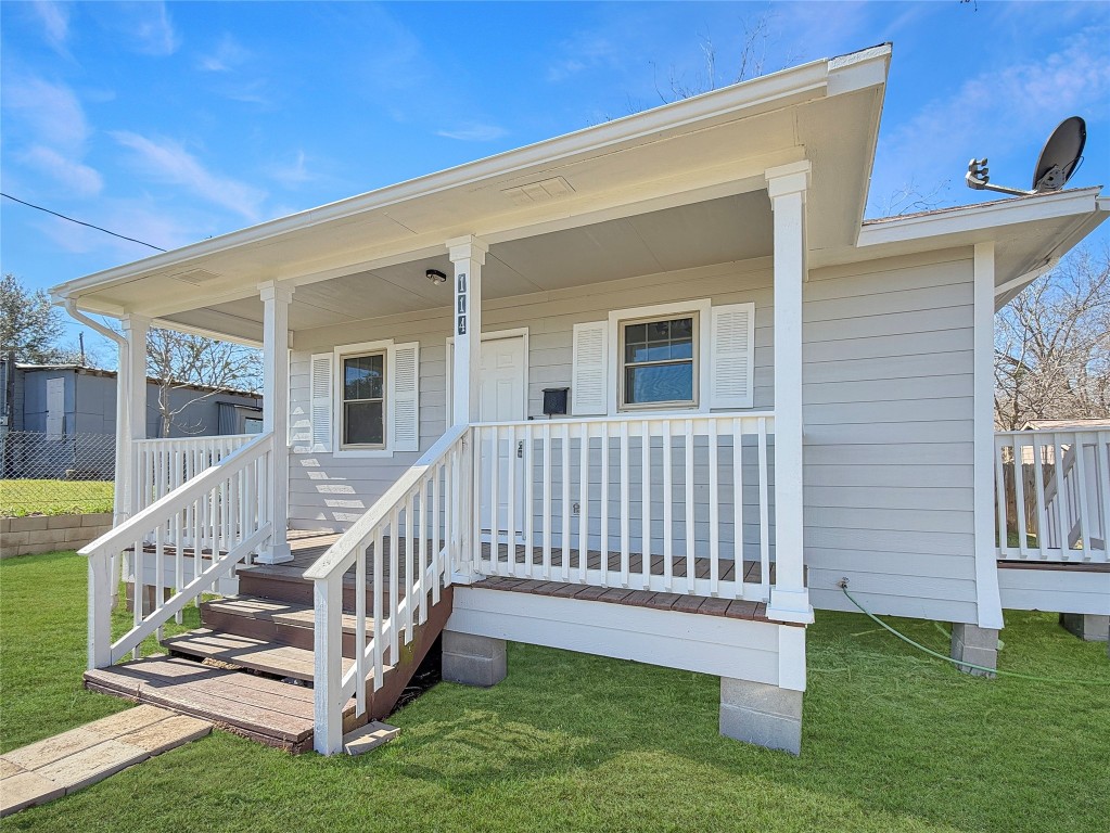 114 8th Street Rosenberg, TX 77471 - Photo 2 of 19 a view of deck with a white house and a yard with plants