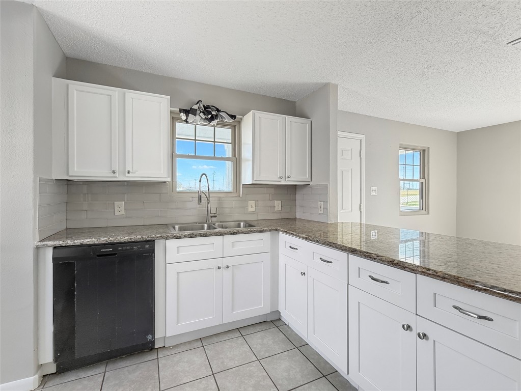 114 8th Street Rosenberg, TX 77471 - Photo 5 of 19 a kitchen with granite countertop white cabinets and white appliances