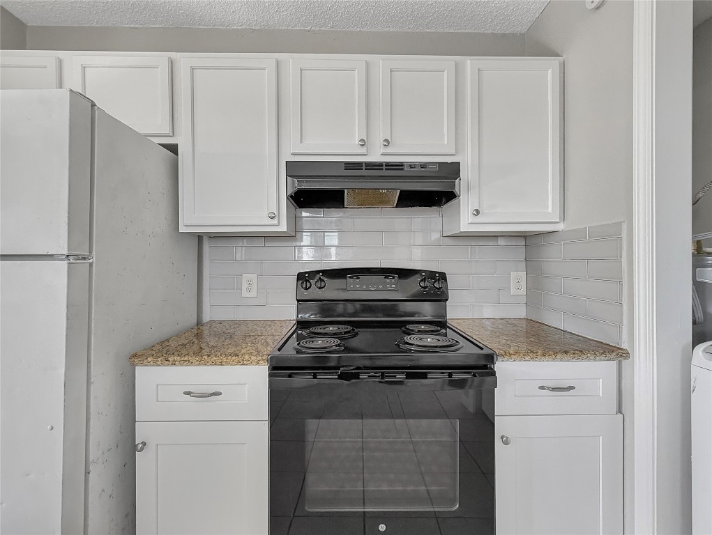 114 8th Street Rosenberg, TX 77471 - Photo 6 of 19 a kitchen with stainless steel appliances granite countertop white cabinets and a stove