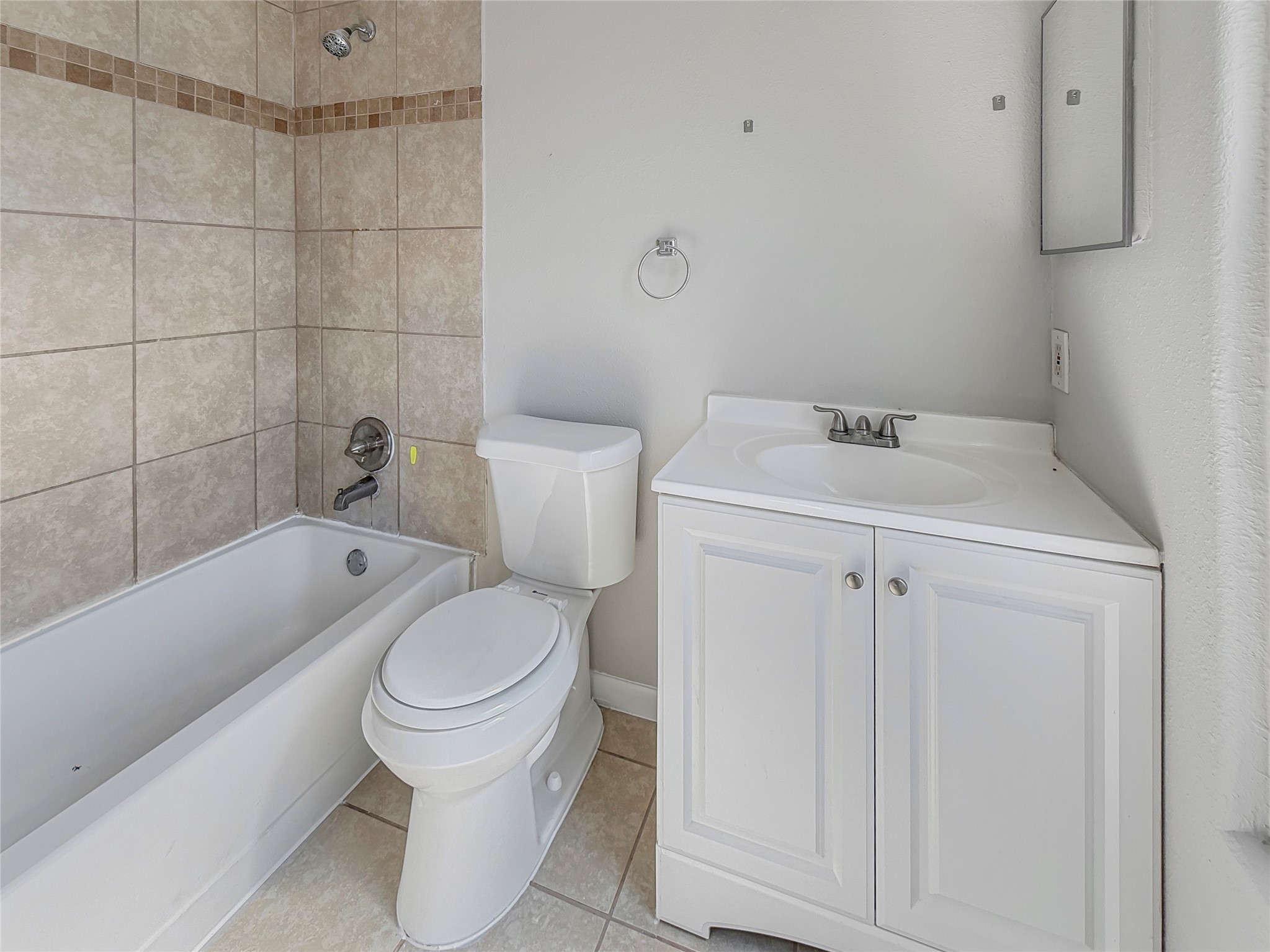 114 8th Street Rosenberg, TX 77471 - Photo 10 of 19 a white toilet sitting next to a bathroom sink and vanity