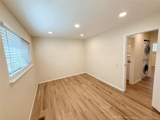 a view of empty room with wooden floor